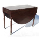 A 19th century mahogany Pembroke table, with oval flaps and fitted with a frieze drawer,