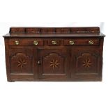 An Antique oak dresser base, the super structure fitted six short drawers over three short drawers,