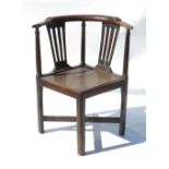 A Georgian oak corner chair, with splat back and solid seat,