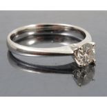 A diamond single stone ring, the white metal mount stamped '750',