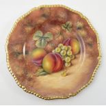 A Royal Worcester cabinet plate, hand painted with fruit to a mossy background by J Smith,