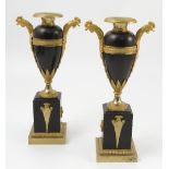 A pair of 19th century ormolu and bronze urns, with cockerel mask handles,