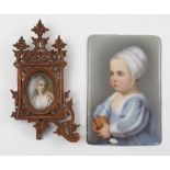 A 19th century portrait miniature, painted on porcelain, of a young child wearing a bonnet,