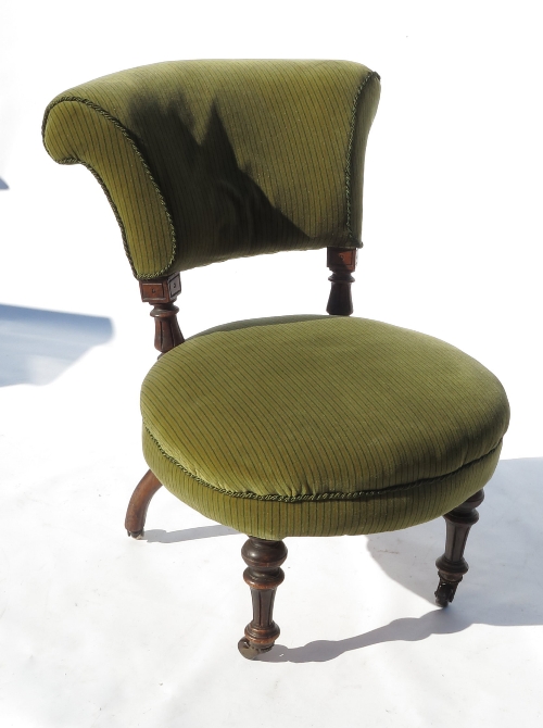 A 19th century nursing chair, with circular seat and padded back,