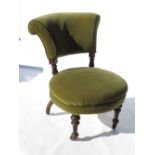 A 19th century nursing chair, with circular seat and padded back,