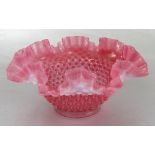 A 19th century cranberry and opalescent glass bowl, with dimpled decoration and ribbon edge,