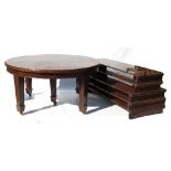 An Edwardian mahogany dining table, of circular form, raised on square tapering legs,