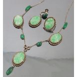 A jade style necklace, the three oval carved panels with green agate cabochons between,