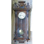 A 19th century walnut cased Vienna style wall clock, with white enamel dial and Roman numerals,