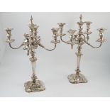 A pair of Mappin and Webb silver five light candelabra, with four scroll branches,