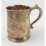 A silver pint mug, of baluster form, raised on a circular stepped foot, London 1926,