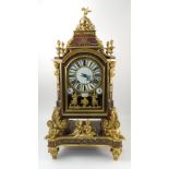 An Antique red tortoiseshell and ormolu bracket clock, with circular enamelled dial,