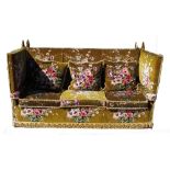 A Knoll settee, the upholstery of pink and purple floral design to a green ground,