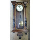 A 19th century walnut cased Vienna style wall clock, with white enamel dial and Roman numerals,