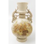 A Royal Worcester gilded ivory vase, decorated with yellow and gilt flowers, with scroll handles,