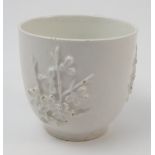 An 18th century Bow white glazed coffee cup, with applied prunus decoration, height 2.