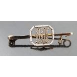 A 15ct gold bar brooch, mounted with a diamond set initial in an enamelled frame,