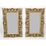 A pair of 19th century gilt framed wall mirrors, the frames decorated with scrolls,