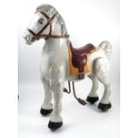 A Mobo pressed metal ride on horse, with leather reins and painted,