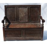 A Georgian style oak box settle, having three panels to the back,