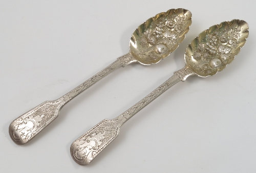 A pair of Georgian silver berry serving spoons, with embossed and engraved decoration, London 1825,