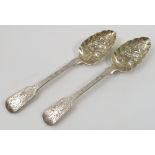 A pair of Georgian silver berry serving spoons, with embossed and engraved decoration, London 1825,