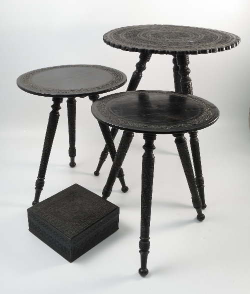 A pair of Indian ebony circular tables, with carved band to the top,