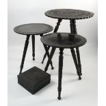 A pair of Indian ebony circular tables, with carved band to the top,