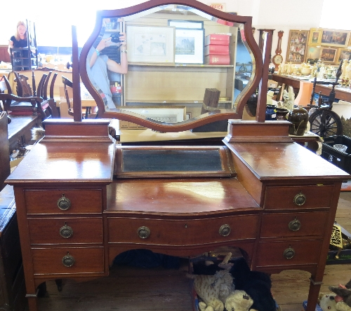 An Edwardian mahogany dressing table, having glazed central compartment, over single drawer,