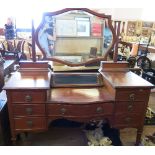 An Edwardian mahogany dressing table, having glazed central compartment, over single drawer,