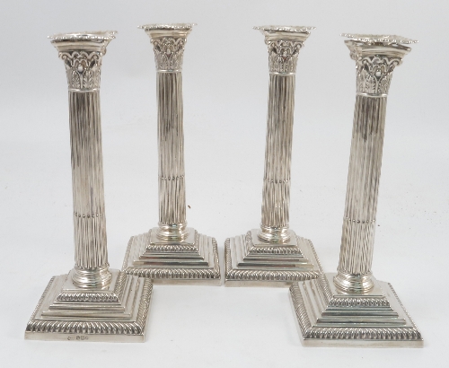 A set of four Mappin and Webb silver candlesticks, modelled as Corinthian columns,