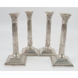 A set of four Mappin and Webb silver candlesticks, modelled as Corinthian columns,