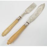 A set of six Victorian silver and ivory handled fish knives and forks, with engraved blades,