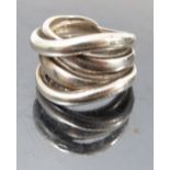 A silver ring, formed as four various bands,