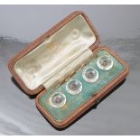 A cased set of four rock crystal and amethyst set dress buttons,