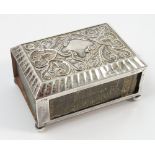 A silver match box holder, with embossed floral scroll and fluted decoration to the top,