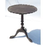 A Georgian design occasional table, with pie crust top with birdcage below, raised on a tripod base,