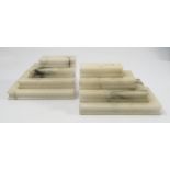A pair of marble book ends, formed as four graduated books lying on their sides, 3ins x 5.