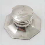 A silver capstan inkwell, of octagonal form, engraved with initials to the lid,