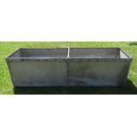 A galvanised iron water trough, with stud decoration and cross bar, length 62ins, width 18.