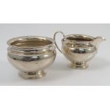 A silver sugar bowl, together with matching milk jug,