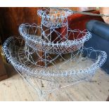 A 19th century style wire work planter, having three tiers with scroll form,