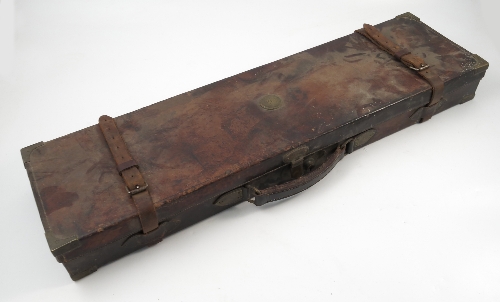 A leather covered gun case, with gilt metal mounts to the corners, leather straps,