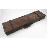 A leather covered gun case, with gilt metal mounts to the corners, leather straps,