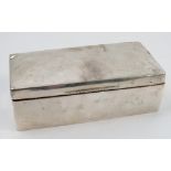 A hallmarked silver cigarette box, of rectangular form with engraved inscription,