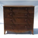 A late Georgian chest, fitted two short drawers over three long drawers, raised on bracket feet,