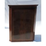 A late 19th century mahogany corner cupboard, with chequer band inlaid door,