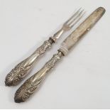 A set of silver handled cutlery, with three pronged forks and embossed silver pistol grip handles,
