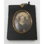A pair of oval over painted portrait prints, of a woman and a man in 19th century dress,