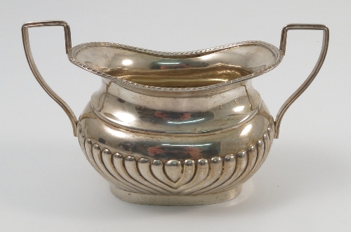 A silver two handled sugar bowl, of oval form with gadrooned edge and lower body, Chester 1903,